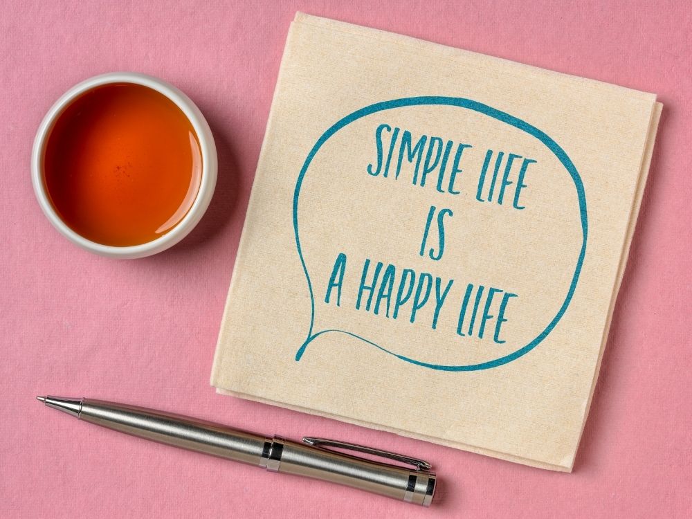 notebook with an inspirational quote that says simple life is a happy life